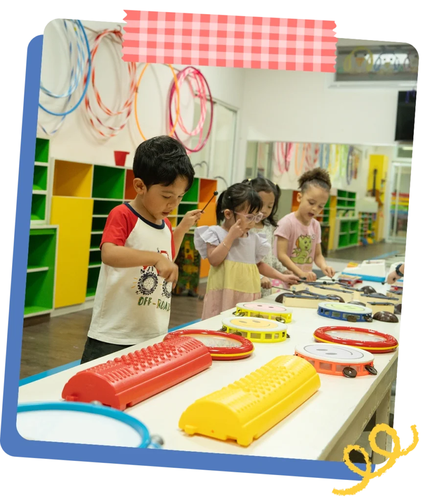 Children sitting together on the classroom floor during a daily rhythm session at CPC