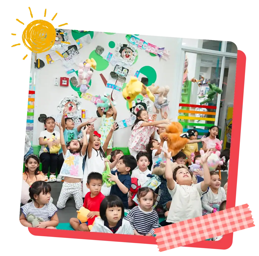A joyful group photo of CPC children and teachers together in the classroom